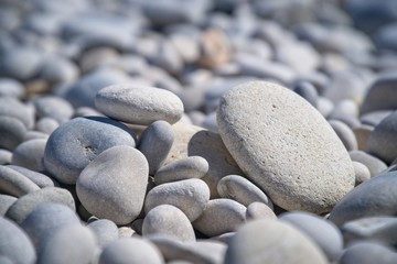 Fototapeta na wymiar sea stones,stones on the beach,.vacation at sea, seashore in Albir, a Spanish beach
