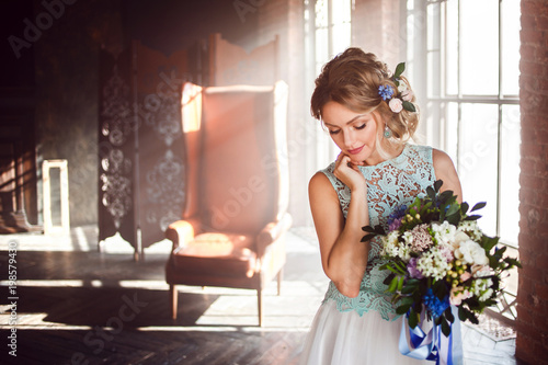 Young Beautiful Woman In Wedding Dress With Bouquet Of