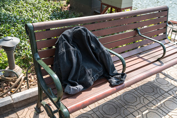 A forgotten jean jacket on park bench