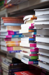 piles of books on the shelves of the archive