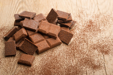 Milk chocolate on a wooden texture