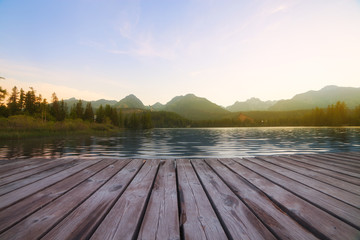 Fototapeta na wymiar Forest Alpine mountain lake and wooden board background