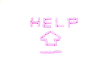 Purple capsules aranged in Text'Help' and arrow in health care for help concept