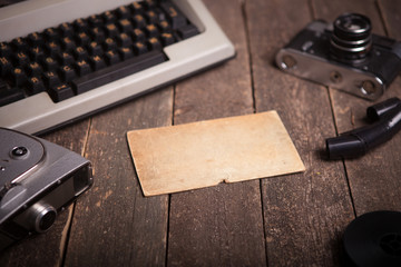 Still life with a typewriter, an old movie camera, a vintage camera оn a textured wooden surface