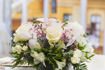  bright bouquet of flowers in a vase stands on a festively decorated wedding table
