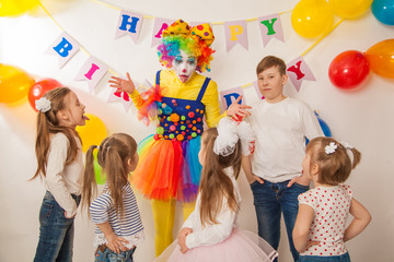 Obraz na płótnie Canvas clown girl on the birthday of a child. Party for children. Play and entertain boys and girls