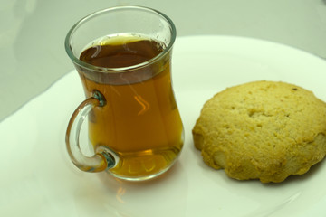 Donut with sugar and cup of hot coffee on wooden table. Top view .