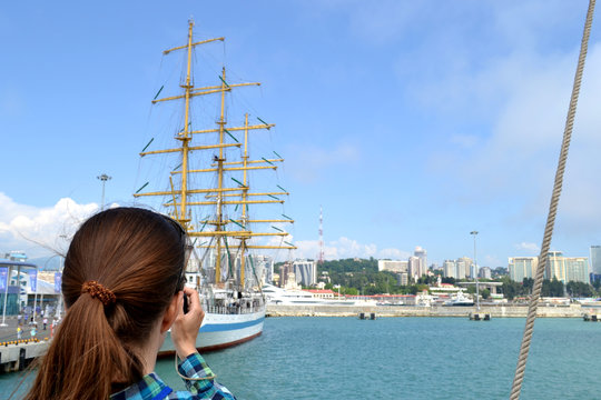 girl taking pictures of the yacht
