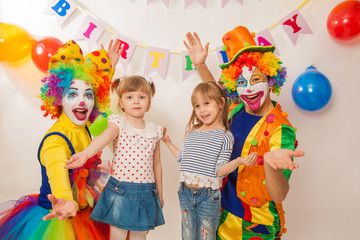 clown girl and clown boy at the birthday of a child. Party for children. Play and entertain boys and girls