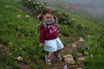 little girl walking in the mountains