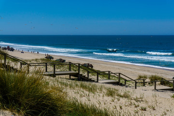 Obraz premium Aerial view of beach and sand dunes at sunset in Murtosa, Aveiro - Portugal. Aerial view.