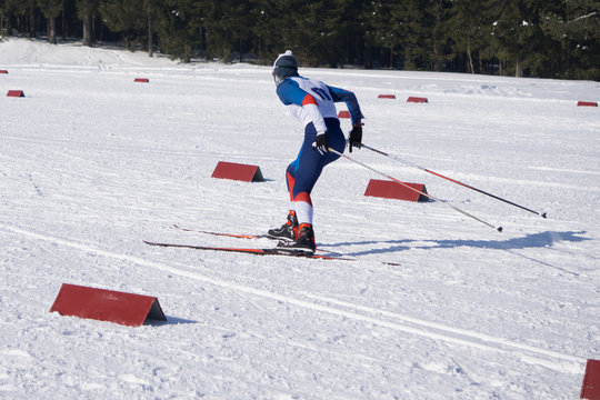 Female skier descends down the slope .