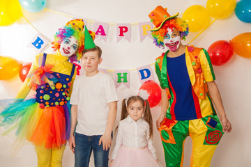 clown boy and clown girl at the birthday of brother and sister. Party for children. Clowns amuse children
