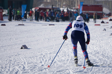 little sportswoman skier during a race in the woods classical style race in the championship .