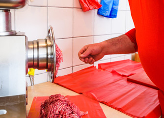 fresh minced meat in butchery shop from meat grinder