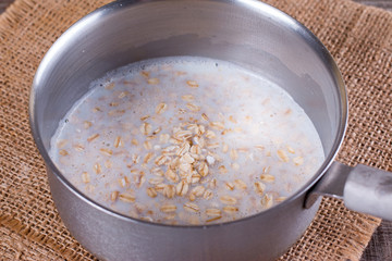 Cooking oatmeal porridge in a saucepan