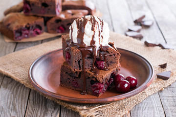 Chocolate brownie with cherry and ice cream