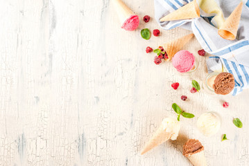 Summer sweet berries and desserts, various of ice cream flavor in cones pink (raspberry), vanilla and chocolate with mint on light concrete background copy space © ricka_kinamoto