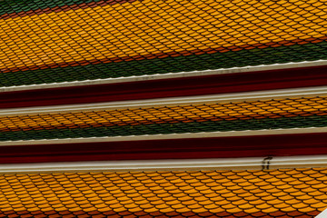 Background – colourful tiles on roof of Buddhist temple