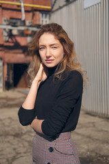 Fototapeta premium Street fashion, urban style. Girl in longsleeve and skirt on backjard