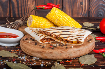 Fajitas serve with flour tortillas on rural wooden board. Food still life