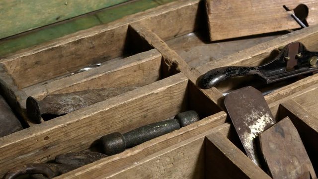 Panning view over old tools in chest showing files and plainer.