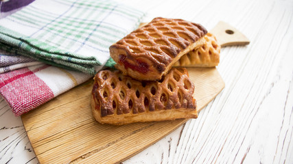 cakes with raspberry jam on the Board of a wooden table