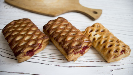 cakes with raspberry jam on the Board of a wooden table