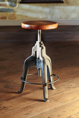 Vintage swivel stool with a massive cast iron base and oak seat standing on wooden floor. Style:...