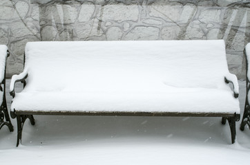 Benches covered with snow