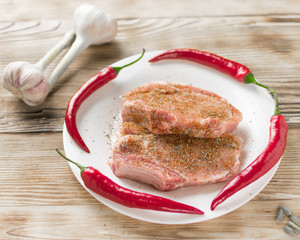 Raw pork ribs with hot red pepper. Preparation of meat for grilling.