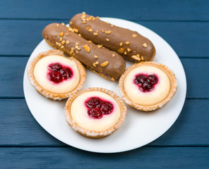 A set of different cakes on a white plate.