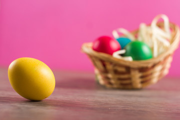 Easter eggs in the easter basket on the bright background
