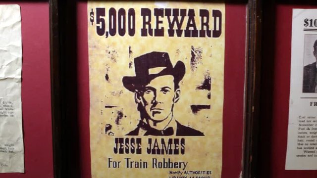 Panning view of Wanted posters from the old west of Frank De Challis, Jesse James, and Clifford Hunt.