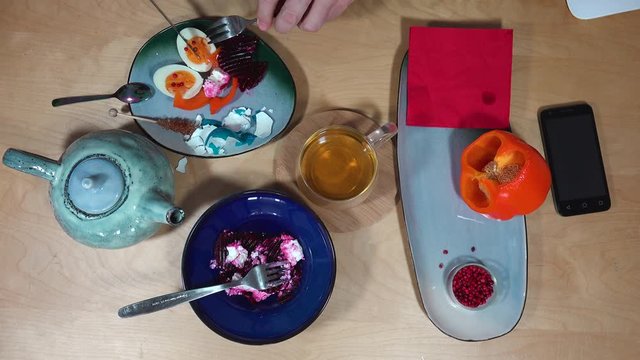 Top view with breakfast, tea, egg, salad and smartphone.