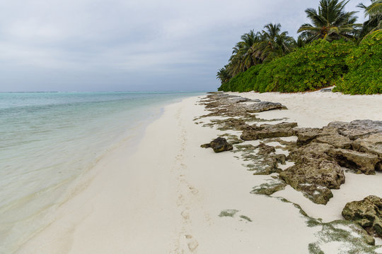 beautiful scenic view of rocks on empty beach and ocean, maldives, thoddoo