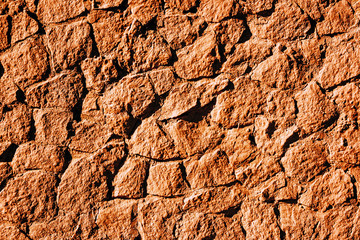Grunge dark brown background of stones