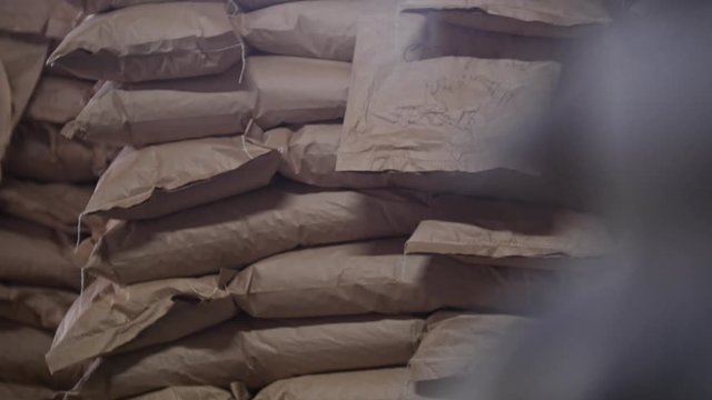 Bags of crystal sugar in the warehouse at sugar refinery
