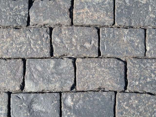 Stone pavement texture. Сobbled pavement background. Old masonry road from gabbro stones