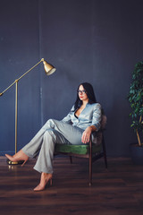 woman in formal wear sitting in modern office interior