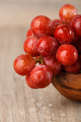 bunch of red grapes in a wooden Cup