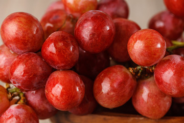 Red grapes on wooden table