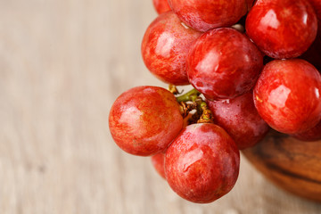 bunch of red grapes in a wooden Cup