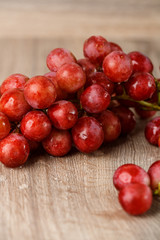 Red grapes on wooden table