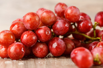 Red grapes on wooden table
