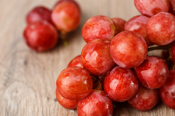 Red grapes on wooden table