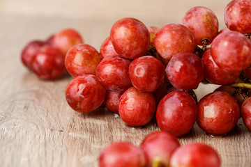 Red grapes on wooden table