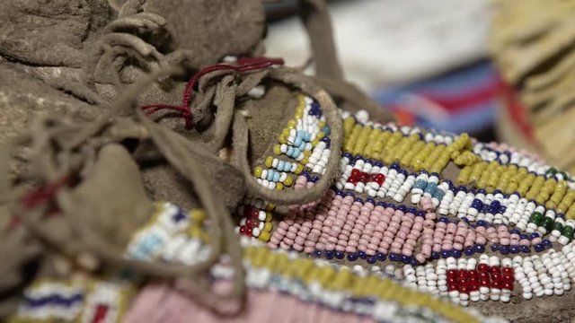 Up close view of moccasins made by Native Americans viewing the colorful beads.