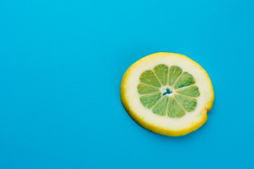 yellow lemon slice against a blue background