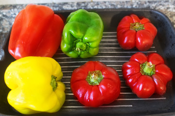 roasting assorted peppers on a griddle